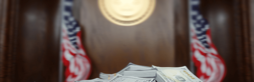 stacks of bills on courtroom desk with american flag poles on each side